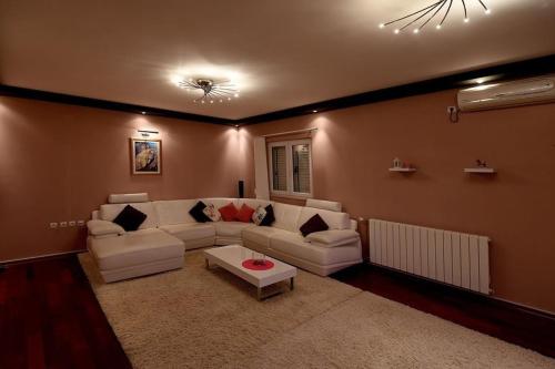 a living room with a couch and a table at Family Villa in Solin with Pool in Solin