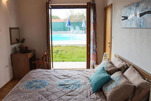 a bedroom with a bed with a view of a pool at Charming Villa near Žminj with Private Pool in Žminj