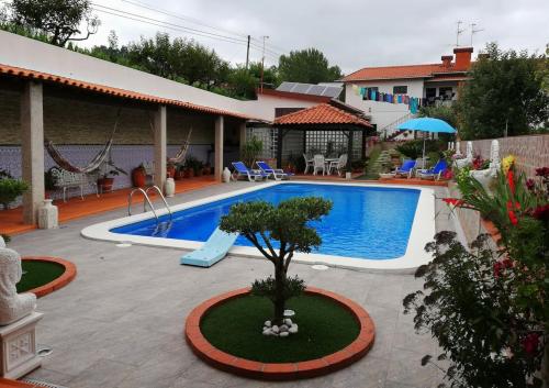 a swimming pool in a yard with a house at Spacious Villa with Private Pool in Oliveira de Azeméis in Oliveira de Azemeis