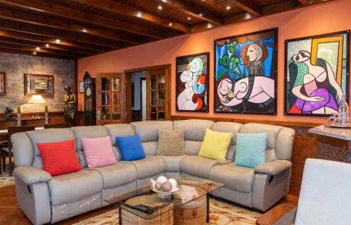 a living room with a couch with colorful pillows at Spacious Villa with Private Pool in Oliveira de Azeméis in Oliveira de Azemeis