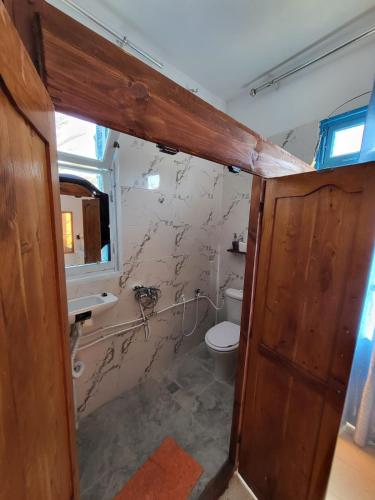 a bathroom with a toilet and a sink at Dar Essadeg Bis in Tataouine