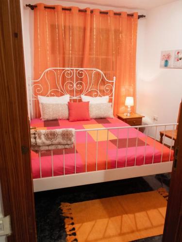 a bedroom with a bed with colorful sheets and pillows at Modern apartment in Frontera, 45 m² with sea view balcony in Frontera