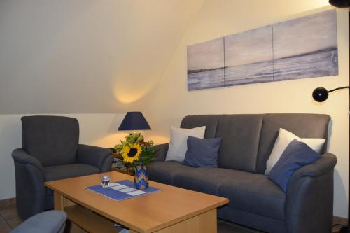a living room with a couch and a table at Waack, Brigitte App Nr 7 in Schönberger Strand