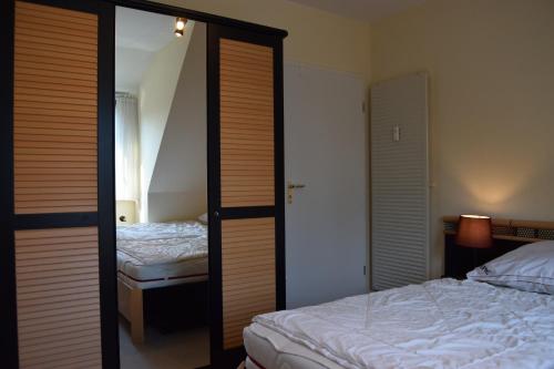 a bedroom with two beds and a sliding glass door at Waack, Brigitte App Nr 7 in Schönberger Strand