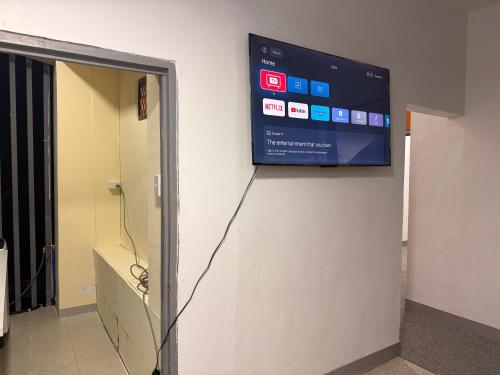 a television on the wall of a hospital hallway at Panatina Sunset Residence in Honiara