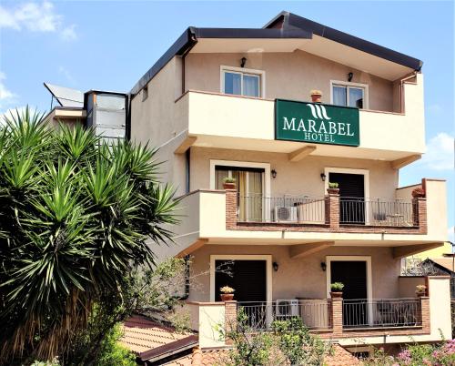 a building with a sign for a marabello hotel at Hotel Marabel in SantʼAlessio Siculo