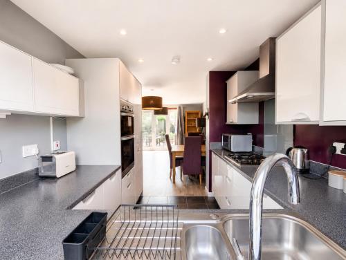 a kitchen with white cabinets and a sink at Chilton Charm Modern 3BR Ideal for Long Stays in Chilton