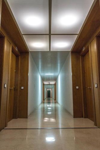 an empty hallway in a building with wooden doors at Modern Apartment in Salou - 50 m² + Pool in Salou