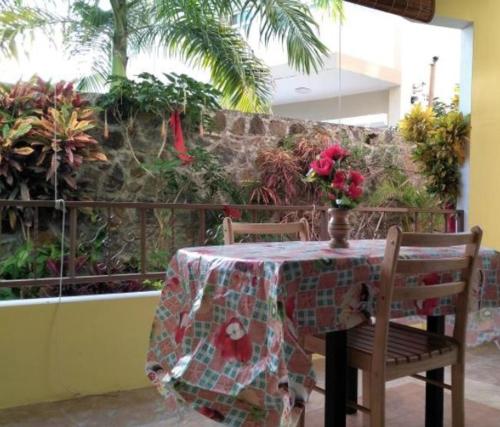 a table with a table cloth on it with two chairs at Charming Apartment in Pereybere with Shared Pool, 75 m² in Pereybere