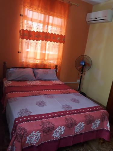 a bedroom with a bed and a window with curtains at Charming Apartment in Pereybere with Shared Pool, 75 m² in Pereybere