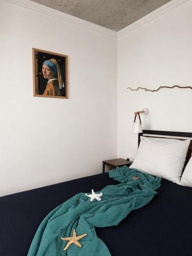 a bedroom with a bed with two starfish on it at Alta Vista Apollonia Sunset in Sozopol