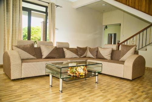 a living room with a couch and a glass table at Luxurious Villa in Pereybere with Pool in Pereybere