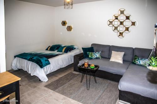 a living room with a couch and a bed at Studio charmant à Abondant, 30 m² avec jardin in Abondant