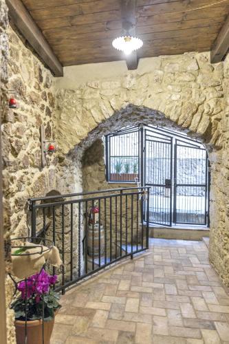 an entrance to a stone building with a gate at Modern Apartment near Arce City Centre, 62 m², Parking in Arce