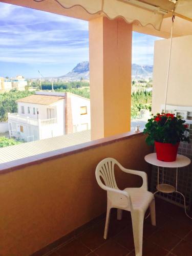 a balcony with a table and a chair and a window at Cozy apartment in Dénia, 40 m² with shared pool in Denia