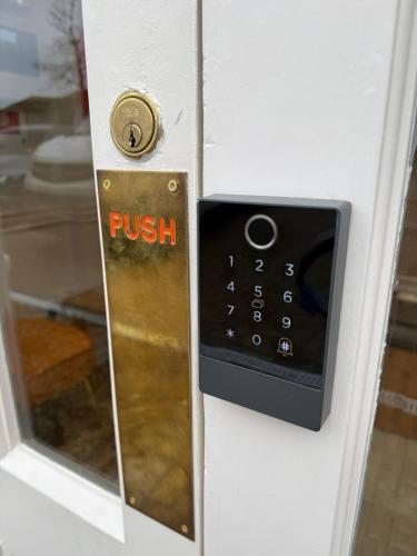 a door with a push sign on the door at Thorpe Lodge Hotel in Peterborough