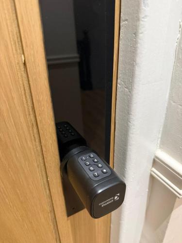 a remote control sticking out of a door at Thorpe Lodge Hotel in Peterborough