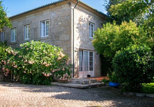 an old stone house with trees in front of it at Charming villa with mountain view in Pedraça, pool in Pedraça