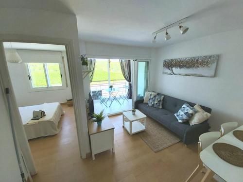 an aerial view of a living room with a couch at Charming apartment with mountain view in Francàs - 45m² in Comarruga