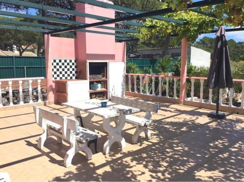 a picnic table and two benches on a patio at Spacious Apartment Sintra 120 m² + Pool in Sintra