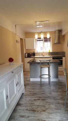 a kitchen with a counter and a table in it at Villa spacieuse avec piscine à Aspin-en-Lavedan, vue montagne. in Aspin-en-Lavedan