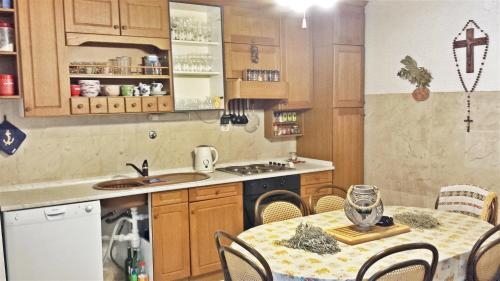 a kitchen with a table and a dining room at Spacious Apartment in Zlarin + terrace in Zlarin