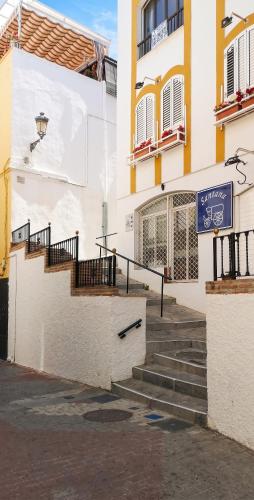 a building with stairs and a sign on it at Comfortable Apartment in Almuñécar in Almuñécar