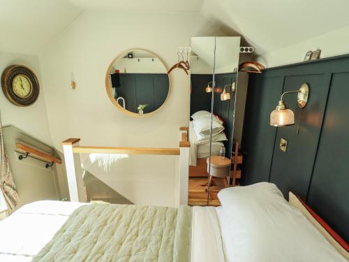 a bedroom with a large bed and a mirror at Hangmans cottage in Horncastle