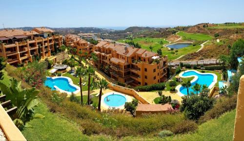 an aerial view of a resort with two swimming pools at Spacious apartment in La Cala de Mijas with sea view. in La Cala de Mijas