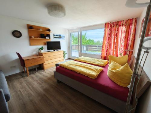 ein Schlafzimmer mit Bett, Fenster und Schreibtisch in der Unterkunft Auszeit mit Sauna und Pool in Scheidegg