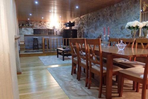 a dining room with a table with chairs and a kitchen at Paradisiacal Villa in Lousada with Private Pool in Lousada