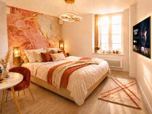 a bedroom with a large bed and a table at MRODBNB - Escapade Romantique - Appart Neuf- 25m Plage & Resto - Ciné - Popcorn - Ciel de Pluie XXL in Cancale