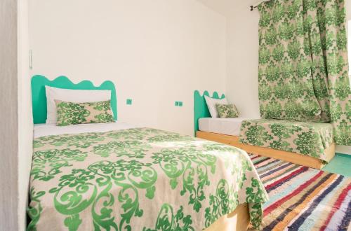a small bedroom with a bed and a chair at Sumptuous Villa in Aït Ben Haddou with Private Pool in Aït Benhaddou