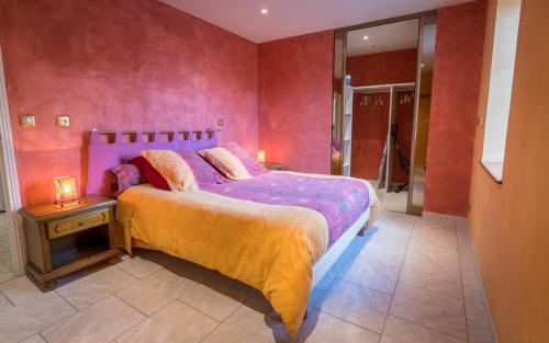 a bedroom with a large bed with a night stand and a table at Maison charmante en campagne à Mouterre-Silly, Jardin, Terrasse. in Mouterre-Silly