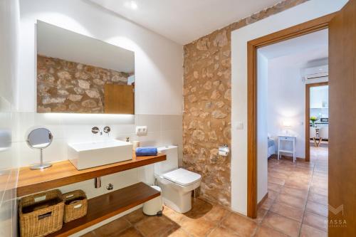 a bathroom with a sink and a toilet at Finca Ca`n Jaumí, un paraíso con vista al mar y a la montaña in Artá