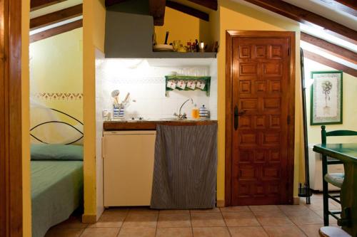 a small kitchen with a sink and a bed in a room at Comfortable Apartment in Robledillo de Gata with Balcony and View in Robledillo de Gata