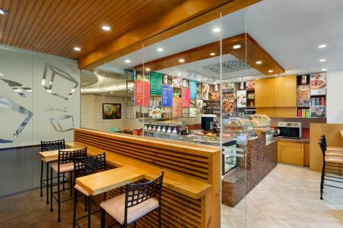 a restaurant with tables and chairs and a counter at Jen Maldives Male by Shangri-La in Male City