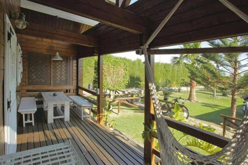 a porch with a hammock and a table and chairs at Charming Bungalow in Tarifa with Mountain View in Tarifa