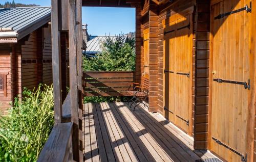 an open door of a wooden cabin with a deck at Chalet cosy à Sixt-Fer-à-Cheval avec vue sur la montagne in Sixt