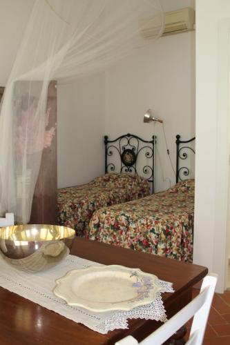 a bedroom with a bed and a table with a bowl at Agriturismo Abbonbri in Quarrata