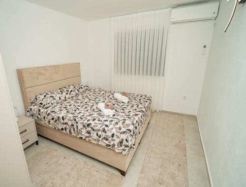 a bedroom with a bed with two stuffed animals on it at Amon Private Pool Residence in Podgorica