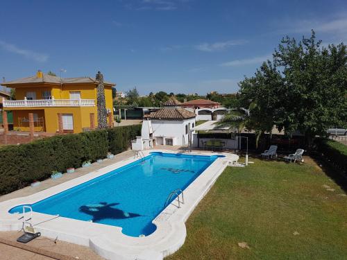a large swimming pool in a yard next to a house at Charming Villa in Linares with Private Pool in Jaén