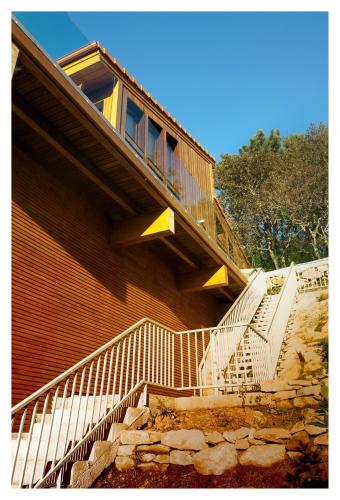 a building with stairs leading up to a house at Elegant Villa in Outes with Pool in Serantes