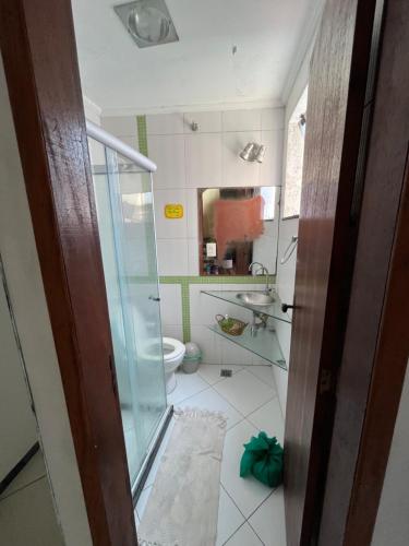 a bathroom with a glass shower and a toilet at Preservar hostel in Cabo Frio