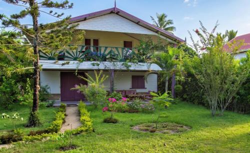 a house with a garden in front of it at Charming Villa in Foulpointe with Sea View in Foulpointe