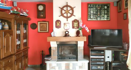 a living room with a fireplace and a flat screen tv at Elegant Villa in Tui with Private Pool in Tui