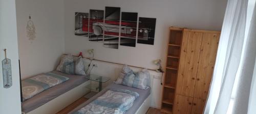 a small room with two beds and a cabinet at Zimmer zum Viadukt in Neulengbach