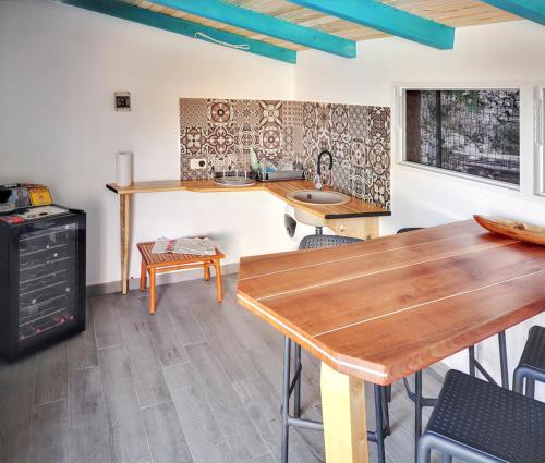 a kitchen with a wooden table and a sink at Charming Villa in Filozići with Private Pool in Filozići