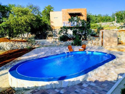 a swimming pool in a yard with a house at Charming Villa in Filozići with Private Pool in Filozići