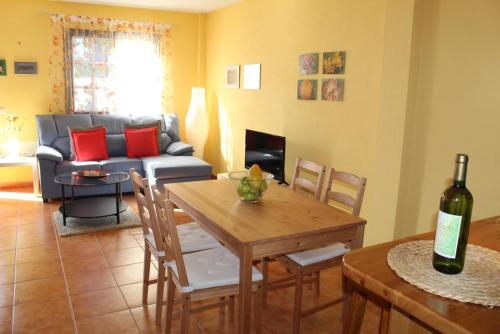 a living room with a table and a couch at Cosy chalet with panoramic views in Icod de los Vinos - 70m² in Icod de los Vinos